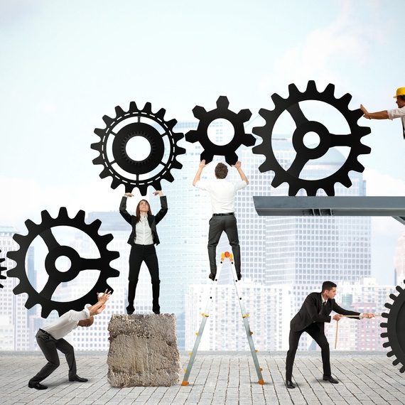 Teamwork of businesspeople Teamwork works together to build a gear system